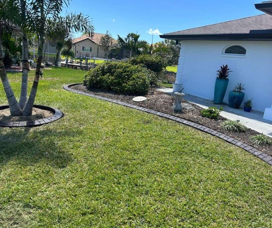 Beautifully maintained lawn and concrete curbing by Fine Design lawn care