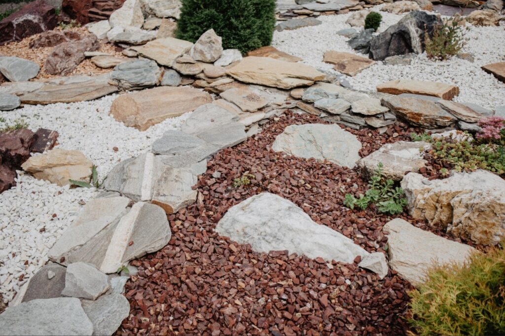 river rock vs mulch | Professional installing decorative landscape materials at a Florida home