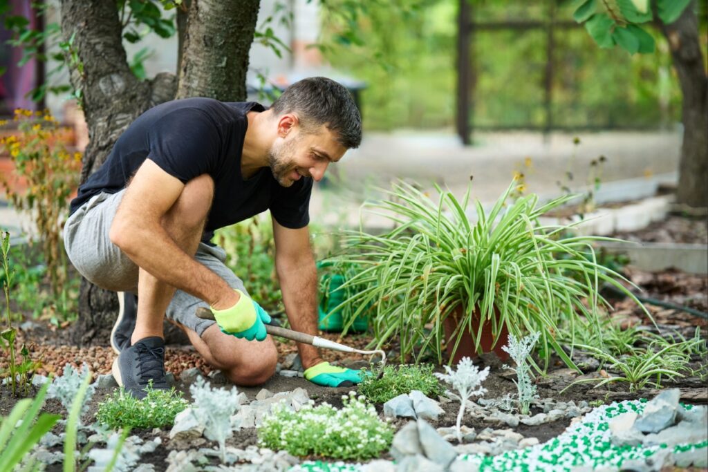 river rock vs mulch | Professional installing decorative landscape materials at a Florida home