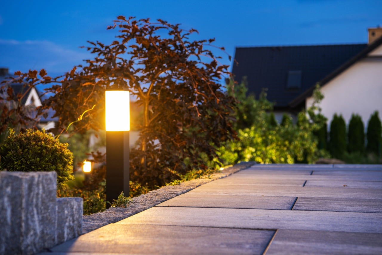 Outdoor lighting Port Charlotte home with illuminated walkway patio and landscaping