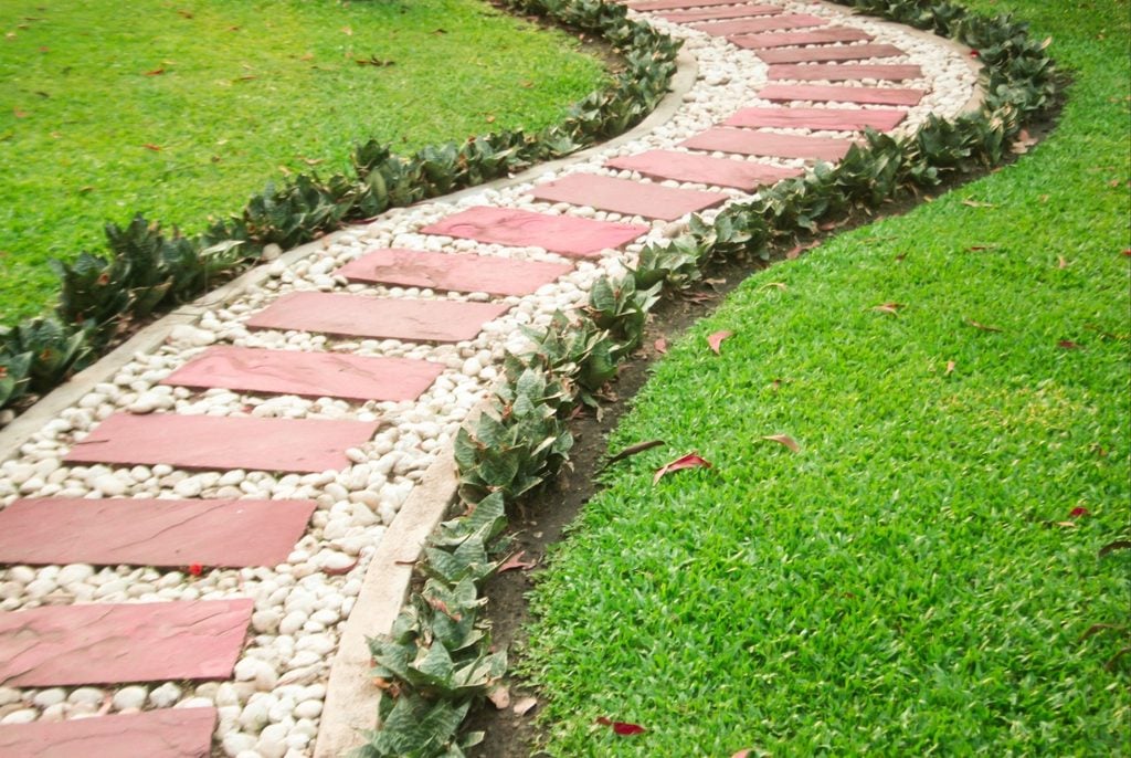 Is Concrete Curbing Right for Your Port Charlotte Landscape Beds? 2 Established landscape beds with concrete curbing around residential lawn in Port Charlotte