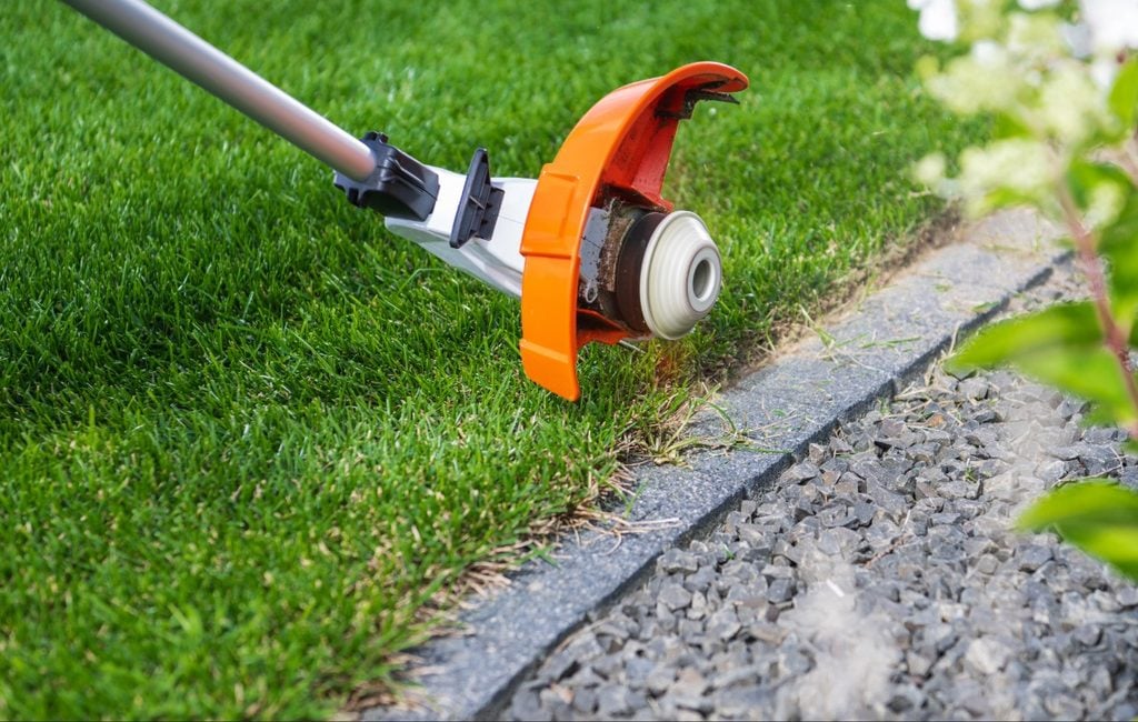 Is Concrete Curbing Right for Your Port Charlotte Landscape Beds? 5 Lawn maintenance beside concrete curbing Port Charlotte residential landscape bed