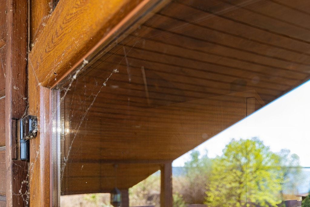 Spider webs keep coming back in the corners of a covered porch in Port Charlotte FL